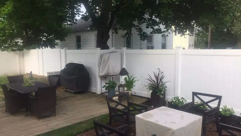 White vinyl privacy fence with patio setting by Fencing By Excellence near Howell, Monmouth County NJ