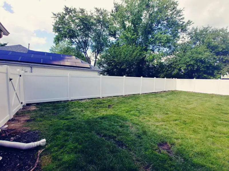 Vinyl fencing along property line by Fencing By Excellence near Freehold, Monmouth County NJ