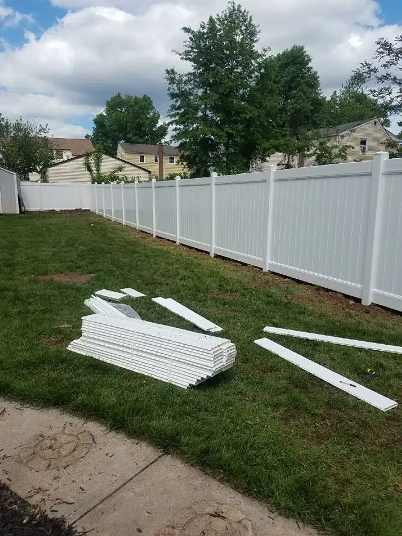 Vinyl fence installation near trees by Fencing By Excellence near Freehold, Monmouth County NJ
