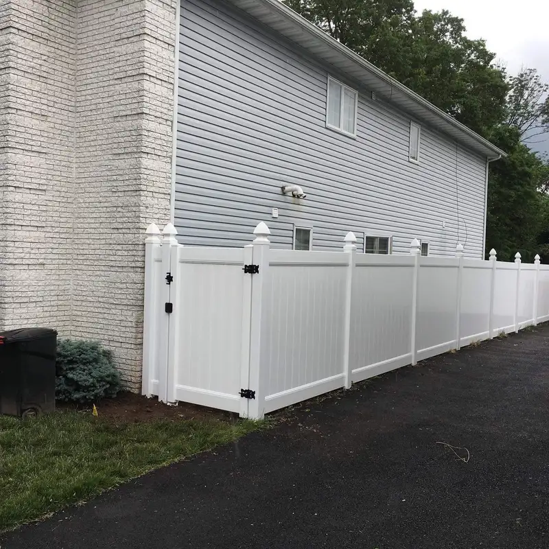White vinyl privacy fence with gate and black hardware by Fencing By Excellence near Union Beach, Monmouth County NJ